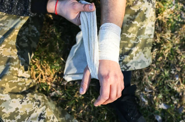 Man Putting Bandage Sprained Wrist Twisted Arm Injured Tourist Nature — 스톡 사진