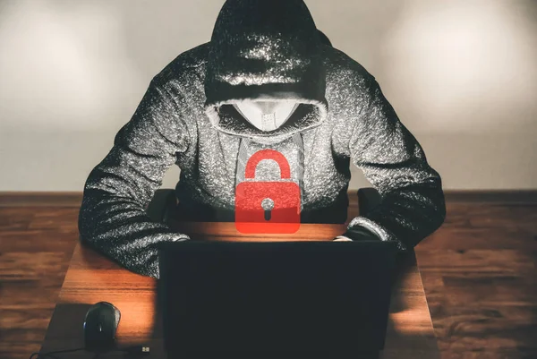 Man in hoodie is hacking personal data. Information security. Protection of information concept. Bad password.