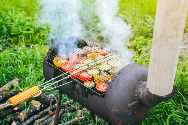 Vegetables on grill outdoors. Vegan barbecue on fire in summer. Good time. Cooking food in the nature. Healthy lifestyle.