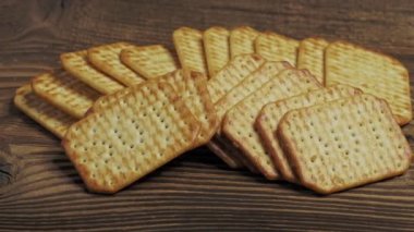 Dry salty cracker cookies isolated on wooden background