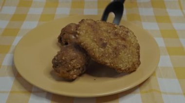 Crispy fried breast and legs from chicken. Homemade breaded schnitzel.