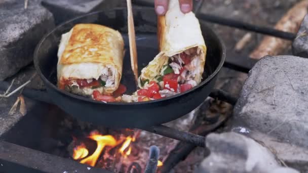 Cooking Meat Shawarma Wrapped in Pita on Outdoor, Burning Bonfire, in Pan. 4K — Stok Video