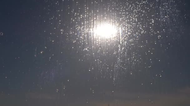 Raindrops Run Down the Glass in de reflectie van de zonnestralen bij zonsondergang. Zoom — Stockvideo