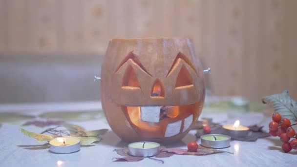 Pumpkin Head in Smoke with Smiling Face of Jack Lantern, Burning Candles in Room — Stock Video