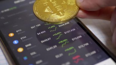 Adam, Şifreleme Para Büyümesini Gösteren Akıllı Telefon Ekranında Bitcoin Bozukluğunu Döndürür