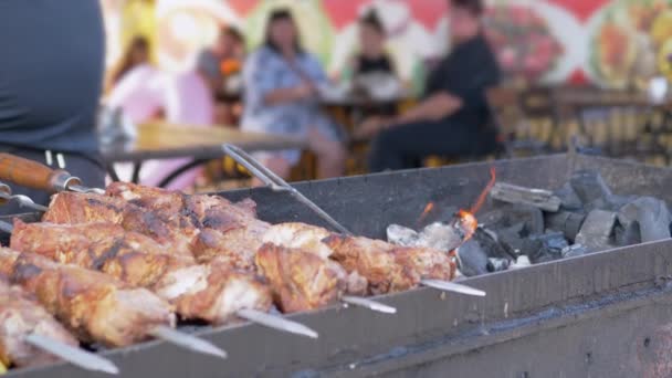 Сочная аппетитная свиная кебаб жарят в дыму на гриле, над открытым огнем — стоковое видео