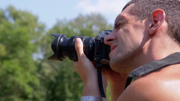 Un fotógrafo tomando fotos de la naturaleza, paisaje de verano. — Vídeo de stock