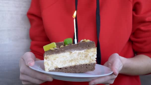 A Teenager Blows Out One Candle on a Piece of Birthday Chocolate Cake. 4K — Video Stock