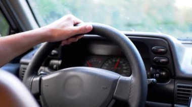 Male Hands Hold the Steering Wheel While Driving of Car. Close up