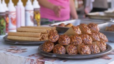 Wafer Rolls with Condensed Milk and Nuts are Sold in an Open Display Case
