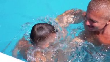 Happy Smiling Father with Son Swim in Open Transparent Swimming Pool. Close up