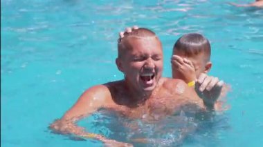 Happy Smiling Father with Son Swim in Open Transparent Swimming Pool. Close up