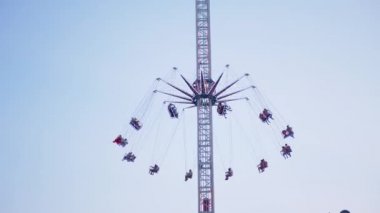 Rotating a Chain Carousel with a Lifting Mechanism in an Amusement Park. 4K