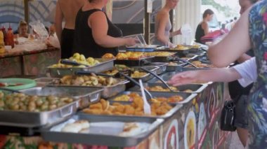 Customers Queuing Ordering Lunch, Pointing Fingers at a Barbecue.