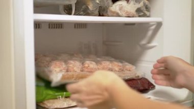 Female Hands Take Out Frozen Semi-Finished Meat Products from Freezer. 4K
