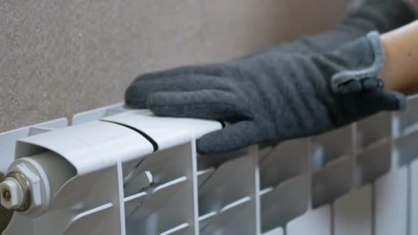 A Female in Woolen Gloves Warms Hands on a Radiator at Home in a Room. Zoom — Video Stock
