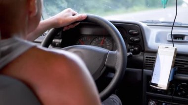 Hareket eden bir arabanın sürücüsü, Mobil Uygulamada akıllı bir telefon üzerinde GPS Navigator kullanır