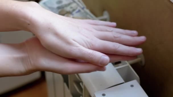 A Woman Warms Hands on a Battery at Home in a Room. 4K. Close up. Slow motion — Video