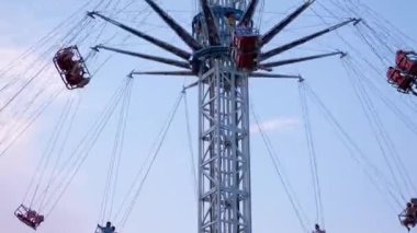 Rotating a Chain Carousel with a Lifting Mechanism in an Amusement Park. Zoom