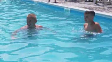 Happy Smiling Father with Son Swim in Open Transparent Swimming Pool. Close up