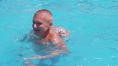 Happy Smiling Father with Son Swim in Open Transparent Swimming Pool. Close up