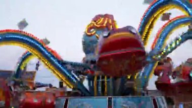 Fast Spinning Carousel of Octopus in an Amusement Park. 4K. Close up
