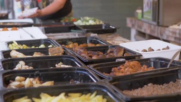 A Lot of Ready-Made Food in Containers is Sold on the Open Counters in a Cafe — Stock video
