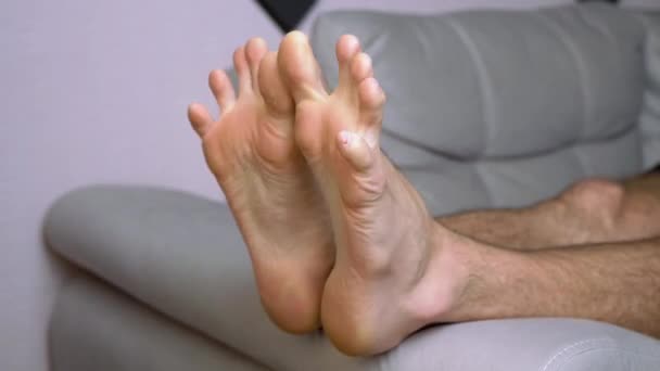 A Male Kneads, Does Gymnastics of Toes, Lying on Sofa. 4K. Close up. Time Lapse — Stock Video