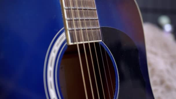 Snaren, gier, body van een blauw akoestisch-elektrische gitaar close-up. 4K — Stockvideo