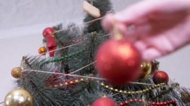 Kadın Eller Noel Ağacı 'nı Noel süsleriyle süslüyor. Büyüt