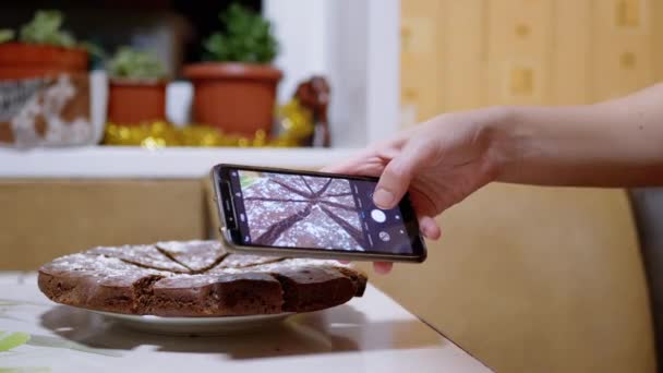 Γυναικεία χέρια Τραβώντας μια φωτογραφία μιας πίτας σοκολάτας στην κουζίνα σε ένα Smart Phone. 4K — Αρχείο Βίντεο
