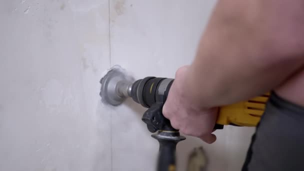 Builder Hands Drill a Hole in a Wall with a Puncher to Install a Socket. — Stockvideo
