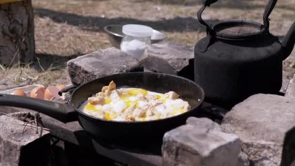 Preparation of Meat Scrambled Eggs in a Frying Pan on the Bonfire. 4K — Stock Video