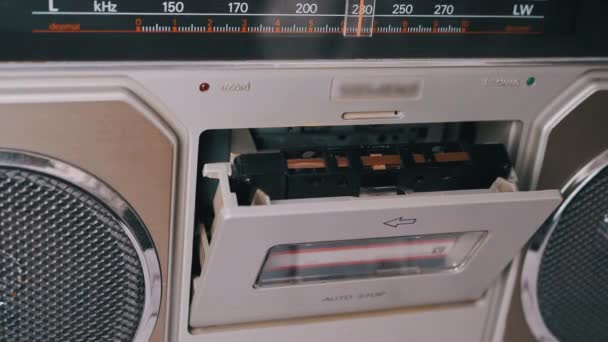 Female Hands Take Out, Turn Over an Old Audio Cassette from a Tape Recorder. 4K — Vídeo de Stock