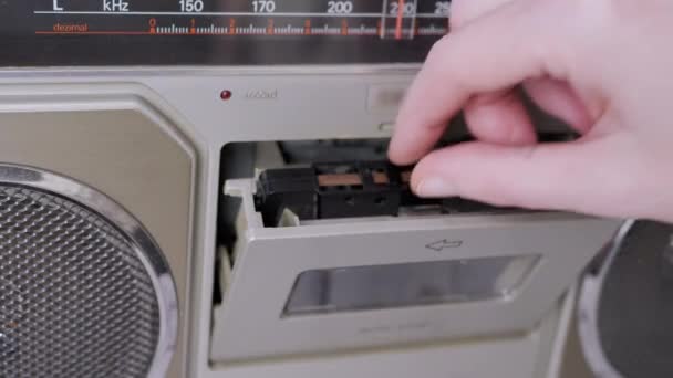 Female Hands Take Out an Old Audio Cassette from a Vintage Tape Recorder. 4K — Stock Video