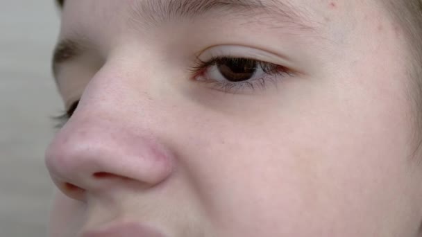 Close-up van Face Knipperend kind met bruine ogen, lange wimpers bij de camera — Stockvideo