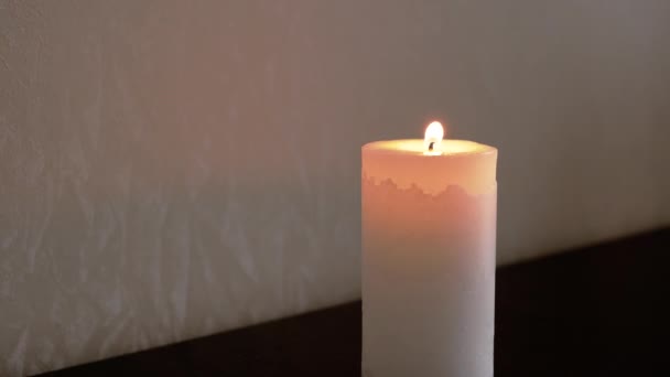 검은 배경 위에 하얀 큰 불을 피우는 촛불 이 있다. 전면 견해 — 비디오