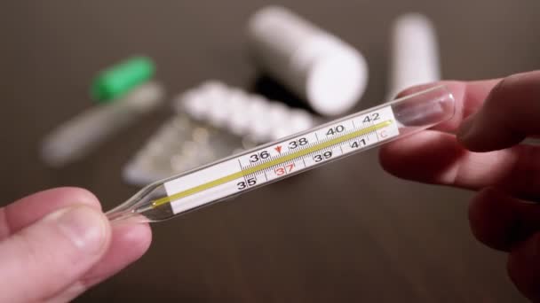 Female Hands Holding a Glass Mercury Thermometer with a High Body Temperature — Stock Video