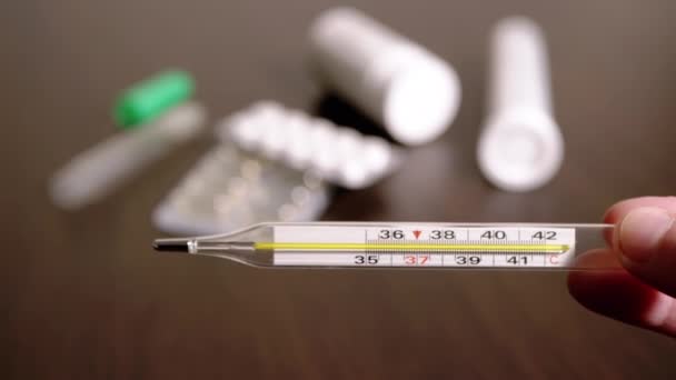 Female Hands Holding a Glass Mercury Thermometer with a High Body Temperature — Stock Video