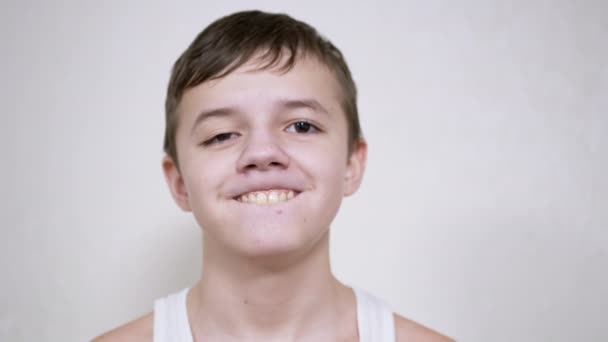 Smiling Teenager Gesticulates with Mouth, Showing his Teeth, Tongue. Close up — Stock Video