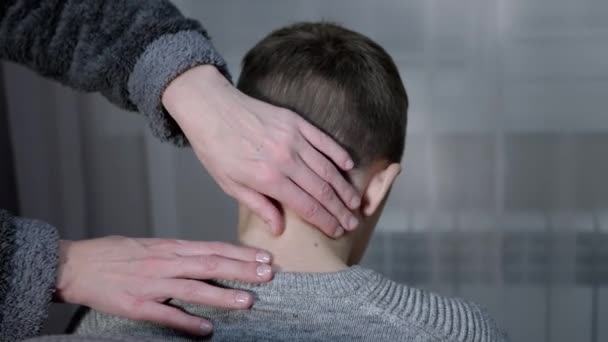 Τα χέρια της μασέρ κάνουν μασάζ στον αυχενικό σπόνδυλο του παιδιού στο σπίτι — Αρχείο Βίντεο