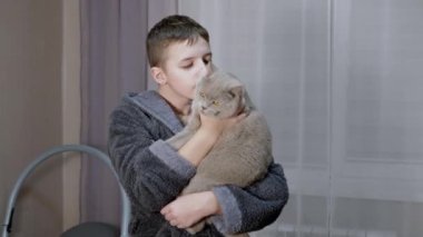 Gülümseyen Çocuk Kucaklıyor, Kucaklıyor, Yumuşak Kediyi Odasında Öpüyor. 4K