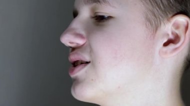 Gülümseyen Gençlerin Aşağı Bakışları 'nın yüz profilinin yakın çekimi. Yan Görünüm