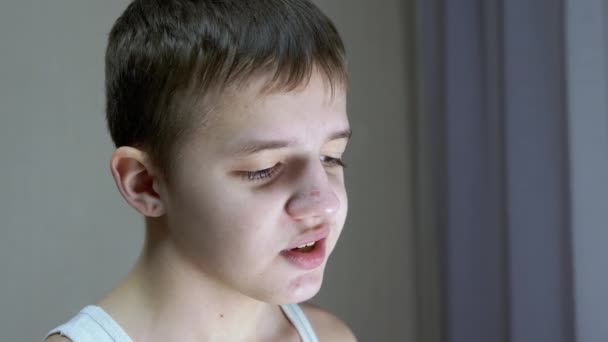 Close-up of a Face Profile of a Talking Smiling Teenager Looking Down. Side View — Stock Video