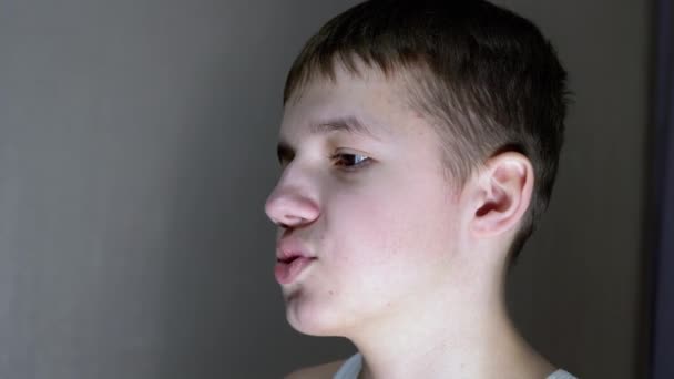 Close-up of a Face Profile of Talking Smiling Teenager Looking Down. Side View — стоковое видео