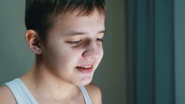 Portrait of a Handsome Smiling Guilty Child with Downcast Eyes, Long Eyelashes — Stock Video