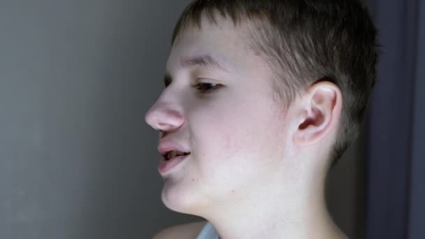 Close-up of a Face Profile of Talking Smiling Teenager Looking Down. Side View — стоковое видео