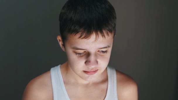 Face Portrait of a Smiling Guilty Child with a Downcast Look. 4K. Close up — Vídeos de Stock