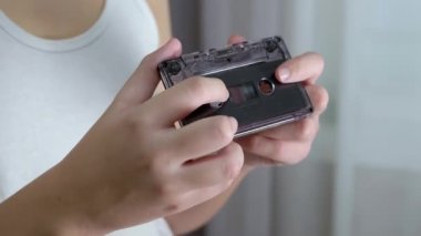 Çocuk elinde Old Black Vintage Ses Kasedini tutuyor, inceliyor. 4K