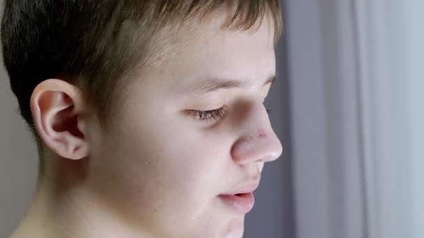 Close-up of a Face Profile of Talking Smiling Teenager Looking Down. Side View — Stock Video